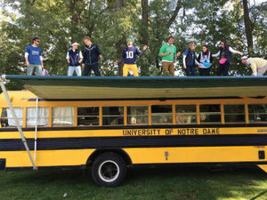 Notre Dame students dancing on top of bus