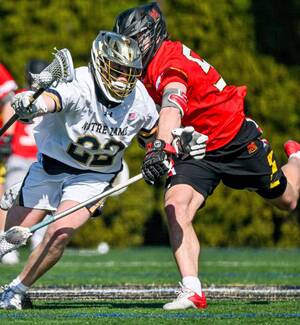 Midfield Will Lynch collides with a Maryland player.