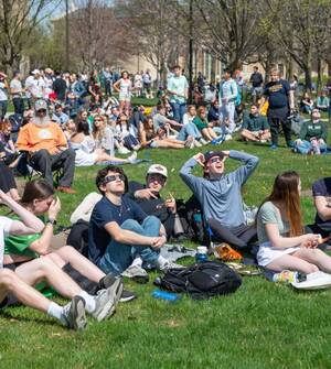 Students watch solar eclipse with special glasses, Courtesy of ND Photos