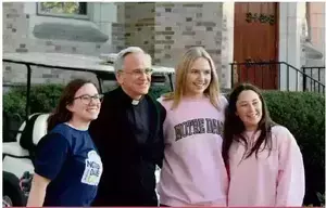 Fr. Jenkins greets students during his retirement celebration. Photo Courtesy of Elle Brouillete