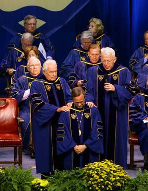 Frs. Hesburgh and Maloy praying for Fr. Jenkins