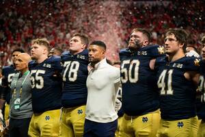 The Irish sing a grim Alma Mater after the game.