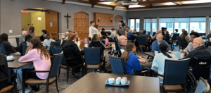 Students spend time with residents at Holy Cross Village, a nonprofit assisted living center and a Mercy Works service site.